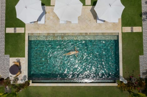 Image of a woman swimming in a pool at a holiday home